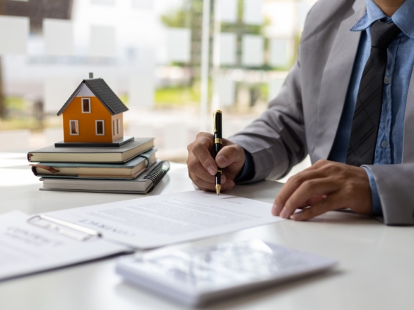 Businessman signs a contract to sell the house legally.